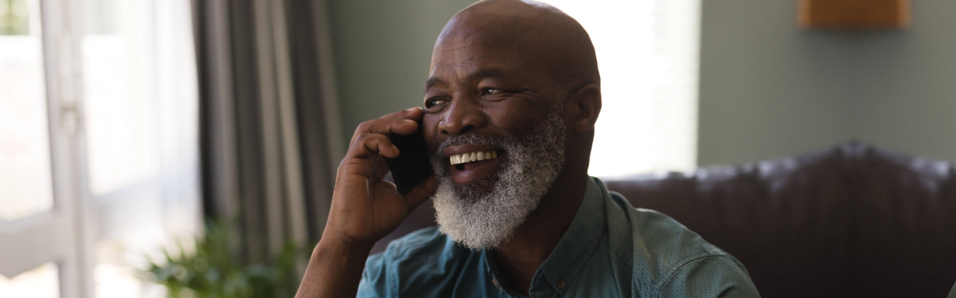 portrait of elderly man calling someone on mobile phone